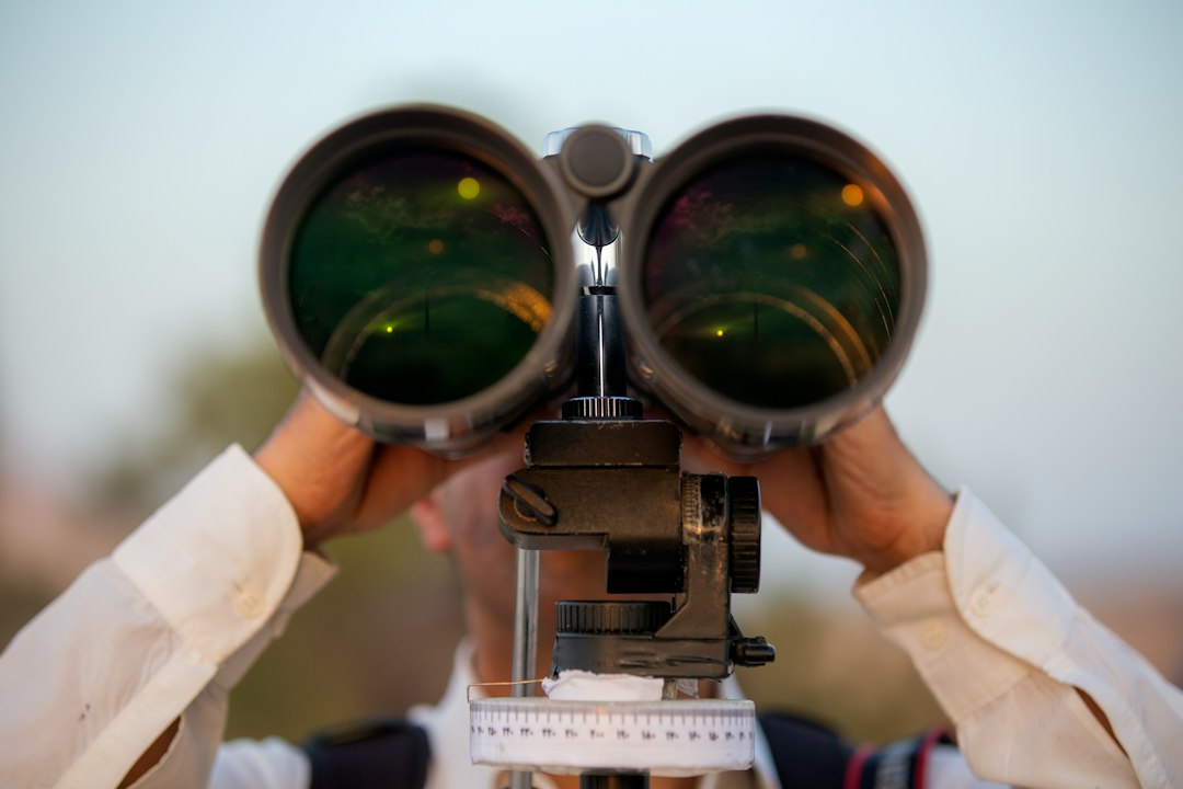 Community members outdoors using binoculars